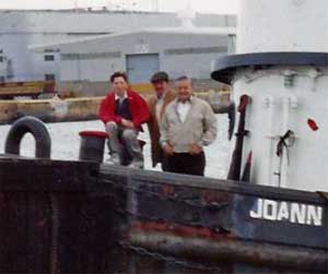 The three Joes on the bow of a tugboat